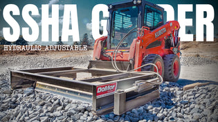  SSHA Hydraulic Adjustable Grader attachment in operation, connected to a red Kubota skid steer loader on a gravel surface, showcasing the grader's sturdy frame and precision in leveling terrain.