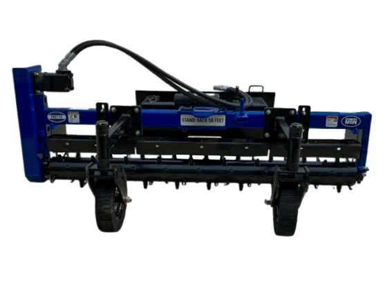A close-up photo of the front of an MTW power rake, showing its blue and black paint, black wheels, and rake teeth.