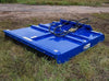 The image shows a Brush Mower-Commercial Series sitting on top of a grassy field. The mower blue with white and black accents.
