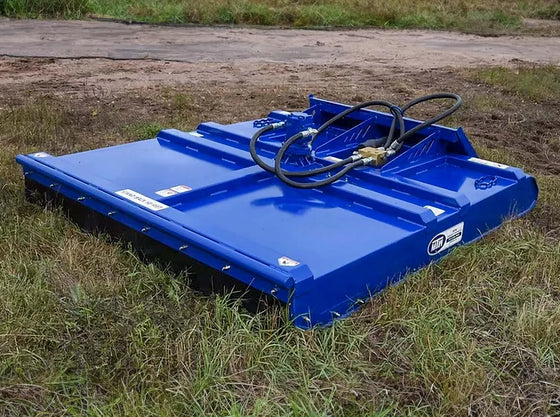 The image shows a Brush Mower-Commercial Series sitting on top of a grassy field. The mower blue with white and black accents.