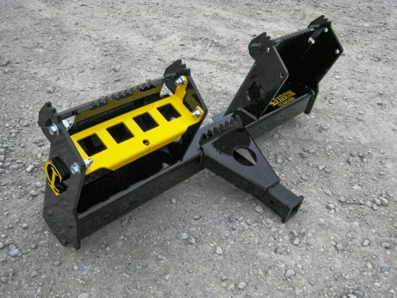 A close-up of a skid steer receiver hitch, showing its black and yellow coloring.