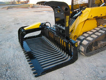  A close-up of the EZ-Grapple bucket attachment, showing its teeth and claws. The teeth and claws are designed to grip and move rocks, logs, and other debris.