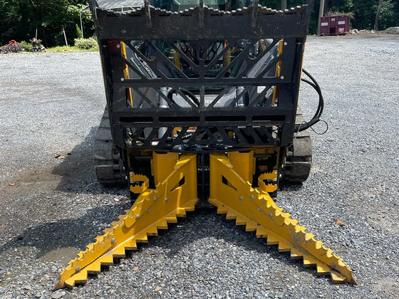 The yellow paint on the grapple guard is likely intended to make it more visible in low-light conditions, while the black accents may help to reduce the appearance of scratches and wear.