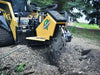 A photo of a stump grinder clearing a field of stumps, before new construction can begin